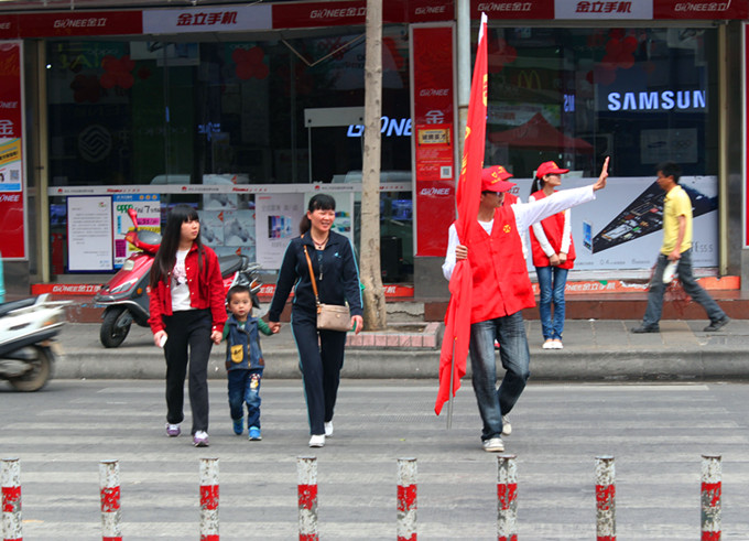 志愿者在引导行人文明过马路